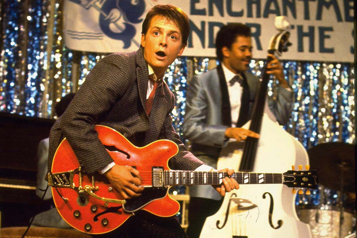 Michael J. Fox as Marty McFly in Back to the Future playing an electric guitar